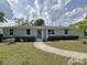 Charming single-story home with a brick facade, well-manicured lawn, and a inviting walkway at 7611 Coteswood Dr., Myrtle Beach, SC 29572