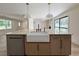 Stylish kitchen island with a farmhouse sink, pendant lighting, and modern cabinetry at 7611 Coteswood Dr., Myrtle Beach, SC 29572