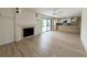 Inviting living area with a fireplace, ceiling fan, and a view into the modern kitchen at 7611 Coteswood Dr., Myrtle Beach, SC 29572