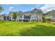 Well-maintained backyard with green lawn, charming patio area, and inviting outdoor seating, perfect for relaxation at 816 Morrall Dr., North Myrtle Beach, SC 29582