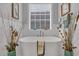A serene soaking tub is surrounded by elegant decor and a bright window with modern blinds at 816 Morrall Dr., North Myrtle Beach, SC 29582