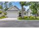 Charming single-Gathering home showcasing a well-manicured lawn, inviting curb appeal, and an attached two-car garage at 816 Morrall Dr., North Myrtle Beach, SC 29582