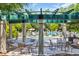 Relax poolside under a decorative pergola with tables and chairs surrounding the spacious pool area at 816 Morrall Dr., North Myrtle Beach, SC 29582