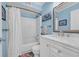 Bright bathroom with a shower-tub combo, white vanity, and beach themed decor at 9661 Shore Dr. # B7-29, Myrtle Beach, SC 29572