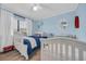 Charming bedroom featuring two twin beds with crisp white bedding and light blue walls at 9661 Shore Dr. # B7-29, Myrtle Beach, SC 29572