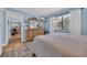 Calming bedroom with wooden dresser, tv, plush rug, and views to the living room at 9661 Shore Dr. # B7-29, Myrtle Beach, SC 29572