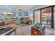Cozy living room with a sofa, stylish ottoman, and a sliding glass door to a private balcony at 9661 Shore Dr. # B7-29, Myrtle Beach, SC 29572