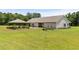The expansive backyard boasts a manicured lawn and a charming gazebo for outdoor activities and relaxation at 971 Mcnabb Rd., Loris, SC 29569