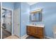 Well-lit bathroom featuring a wooden vanity, a mirror with lighting, and tile flooring at 971 Mcnabb Rd., Loris, SC 29569