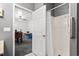 Bathroom featuring a walk-in shower with gray accents, with a peek into an office at 971 Mcnabb Rd., Loris, SC 29569