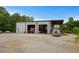 Exterior image showing a large garage with multiple bays, trucks, and ample parking space at 971 Mcnabb Rd., Loris, SC 29569
