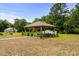 An outdoor gazebo is nestled in a well-manicured lawn, perfect for relaxing or entertaining at 971 Mcnabb Rd., Loris, SC 29569