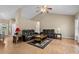 Cozy living room featuring vaulted ceilings, two leather sofas, hardwood flooring, and a ceiling fan at 971 Mcnabb Rd., Loris, SC 29569