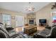 Inviting living room featuring vaulted ceiling, a stone fireplace, hardwood floors, and comfortable furnishings at 971 Mcnabb Rd., Loris, SC 29569