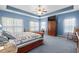 Serene main bedroom with a tray ceiling, cozy furnishings, and bright windows at 971 Mcnabb Rd., Loris, SC 29569