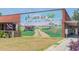 A large mural of Loris S.C. with images of agriculture equipment and fields of crops at 971 Mcnabb Rd., Loris, SC 29569