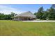 Spacious home featuring a large yard with lush greenery and an attached carport perfect for outdoor enjoyment at 971A Mcnabb Rd., Loris, SC 29569