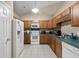Bright kitchen with appliances, white tile flooring, and lots of cabinet space at 971A Mcnabb Rd., Loris, SC 29569