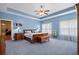 Spacious main bedroom with elegant wood furniture, tray ceilings, and cozy bedding at 971A Mcnabb Rd., Loris, SC 29569