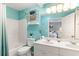 Well-lit bathroom with double vanity, shower-tub combo, and aqua walls at 9776 Leyland Dr. # 2, Myrtle Beach, SC 29572