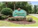 Signage for the 'Savannah Shores Condominium Community' surrounded by landscaping and mature trees at 9776 Leyland Dr. # 2, Myrtle Beach, SC 29572
