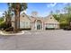 Clubhouse exterior showcasing detailed architecture, well-maintained landscaping, and ample parking at 9776 Leyland Dr. # 2, Myrtle Beach, SC 29572