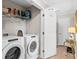 Bright laundry room equipped with side-by-side washer and dryer, shelving and storage at 9776 Leyland Dr. # 2, Myrtle Beach, SC 29572
