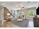 Bright living room featuring a sectional sofa, modern rug, and sun-lit windows at 1098 Laconic Dr., Myrtle Beach, SC 29588
