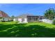 Spacious backyard with green grass and an enclosed patio at 110 Ashworth Dr., Little River, SC 29566