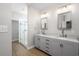 Bathroom featuring double vanities, gray cabinets, modern fixtures, and glass enclosed shower at 110 Ashworth Dr., Little River, SC 29566
