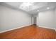 Large bedroom with a trey ceiling, ceiling fan, wood floors, and white trim at 110 Ashworth Dr., Little River, SC 29566