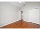 Bedroom with wood floors, double door closet, and ceiling fan with lighting at 110 Ashworth Dr., Little River, SC 29566