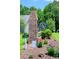Ashton Acres neighborhood sign with brick base surrounded by landscaped flowerbeds at 110 Ashworth Dr., Little River, SC 29566