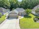 Beautiful single story home featuring an attached garage and manicured lawn and shrubbery at 110 Ashworth Dr., Little River, SC 29566