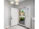 Bright foyer with tile flooring and a view of the front yard through the screen door at 110 Ashworth Dr., Little River, SC 29566