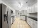 Updated kitchen featuring stainless steel appliances, white cabinets, granite countertops, and tile flooring at 110 Ashworth Dr., Little River, SC 29566
