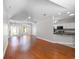 Open-concept living room with vaulted ceilings and hardwood floors, seamlessly connecting to the kitchen at 110 Ashworth Dr., Little River, SC 29566