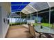 Enclosed patio with outdoor dining table and chairs offering serene backyard views at 110 Ashworth Dr., Little River, SC 29566