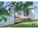 White screened porch with blue roof and white picket fence in landscaped backyard at 110 Ashworth Dr., Little River, SC 29566