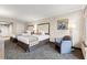 This bedroom has two comfortable beds, a soft armchair, nice artwork, and a beautiful light fixture at 1105 S Ocean Blvd. # 250, Myrtle Beach, SC 29577