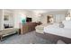 Comfortable bedroom featuring 2 beds, a dresser with a TV, a table with chairs, and a soft armchair at 1105 S Ocean Blvd. # 250, Myrtle Beach, SC 29577