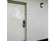 The exterior doorway of unit 250 featuring a light-green door, exterior light fixture, and easy access lock at 1105 S Ocean Blvd. # 250, Myrtle Beach, SC 29577