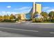 Beautiful condo exterior with lush landscaping, palm trees, a monument sign, and ample parking at 1105 S Ocean Blvd. # 250, Myrtle Beach, SC 29577