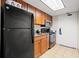 Full kitchen with wood cabinets, tile flooring, and stainless steel microwave at 1105 S Ocean Blvd. # 250, Myrtle Beach, SC 29577