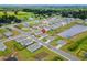 Aerial view of a neighborhood with lush green lawns, a pond, and convenient road access at 115 Spring Wheat Way, Conway, SC 29527