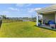 Backyard featuring a patio, grill, grassy area, lake, and fencing for privacy at 115 Spring Wheat Way, Conway, SC 29527