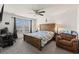 Bright bedroom features a wooden bed frame, plush carpeting, and a calming view of the outdoors at 115 Spring Wheat Way, Conway, SC 29527