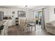 Cozy dining area featuring a dining table set for six with sliding glass doors leading to the backyard at 115 Spring Wheat Way, Conway, SC 29527