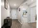 Well-lit hallway with hardwood floors and white trim, leading to bedrooms and living spaces at 115 Spring Wheat Way, Conway, SC 29527