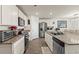 Modern kitchen boasts stainless steel appliances, granite countertops, and ample white cabinetry at 115 Spring Wheat Way, Conway, SC 29527